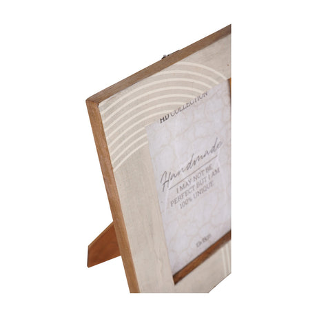 Libra Interiors Arched Line mango wood photo frame in cream with curved line detail and fold-out easel back, shown from an angled close-up view.
