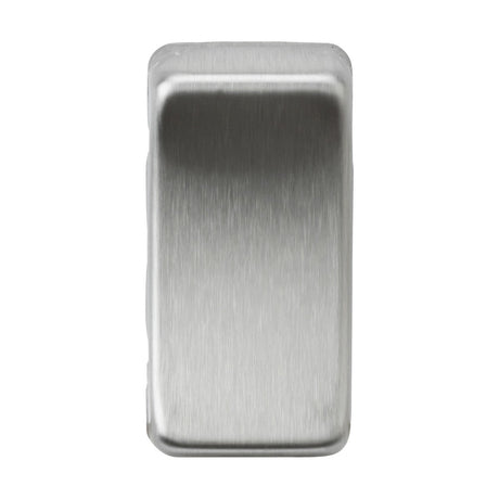 The Switch Cover - Brushed Chrome, a sleek and metallic rectangular block, stands upright against a plain white background, its polished surfaces glistening in the light.