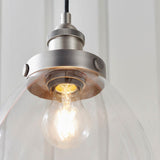 Wentworth Pendant Light in silver, showing a clear glass bell shade with knurled metal lamp holder and exposed filament bulb, industrial style.