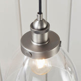 Wentworth Pendant Light in Silver, close-up of the knurled E27 lamp holder and clear glass shade with exposed filament bulb, industrial style.