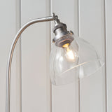 Close-up of the Endon Wentworth table lamp in silver, showing the curved arm, knurled adjustable knuckle, clear glass shade and exposed filament bulb.