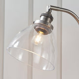 Close-up of the Endon Wentworth table lamp's clear glass dome shade, brushed silver knurled lamp holder, adjustable knuckle, and exposed E14 filament bulb.