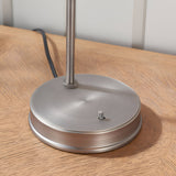 Close-up of the Endon Wentworth table lamp's round brushed silver base with knurled fitting detail, shown on a wooden surface.