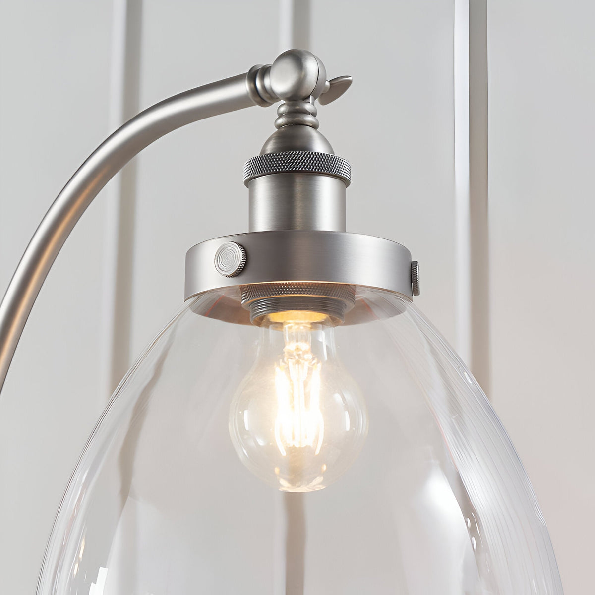 Endon Wentworth silver floor lamp close-up showing knurled brushed metal holder, adjustable knuckle and clear glass shade with E27 filament bulb.