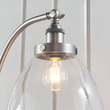 Endon Wentworth silver floor lamp close-up showing knurled brushed metal holder, adjustable knuckle and clear glass shade with E27 filament bulb.