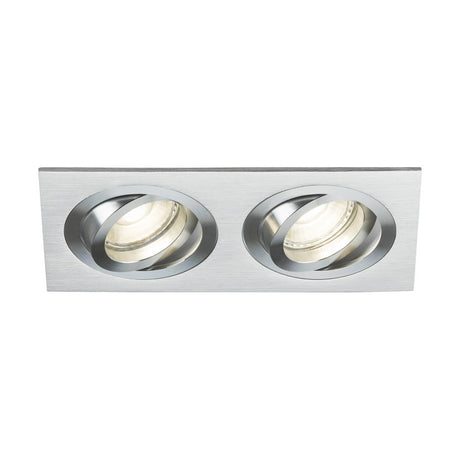 The Ambar Twin Tilt Square Downlight in brushed chrome is a rectangular recessed ceiling light fixture featuring two circular adjustable spotlights, making it an ideal addition to architectural lighting. This piece brings sophistication and versatility to any modern interior.