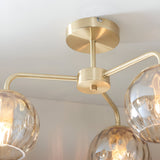Close-up of the Endon Everly 3 Light Semi-Flush Ceiling Light in gold, showing the brushed brass ceiling plate, central stem and glass globe shades.