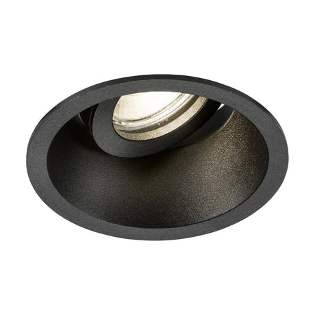 The Dipa Single Tilt Recessed Round Downlight in black showcases a circular design with a visible bulb nestled within its deep, round housing. This product provides discrete low glare lighting and is compatible with Knightsbridge GU10 light sources, ideal for delivering subtle and focused illumination in indoor spaces.