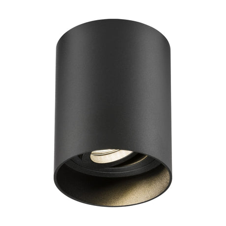 The Oran Surface Dimmable Tilt Round Downlight in black is a sleek, minimalist ceiling light fixture with a cylindrical design. This Knightsbridge architectural downlight showcases a modern aesthetic with its surface mount installation, and the bulb socket is elegantly housed within the cylinder's interior.