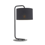 Caldfield Table Lamp in satin black, featuring a curved metal stand and drum fabric shade, shown on a plain white background.
