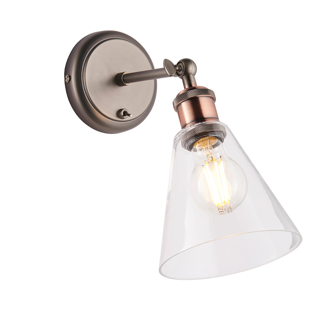 Brackley industrial wall light with round pewter backplate, adjustable copper fitting and cone-shaped clear glass shade with exposed bulb.