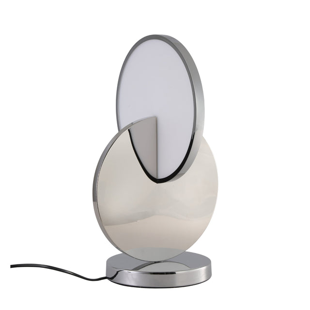 The Half Moon LED Table Lamp - Silver features a modern design with interlocking circular shapes—one metallic silver, one white—set on a chrome base and finished with a sleek black power cord.