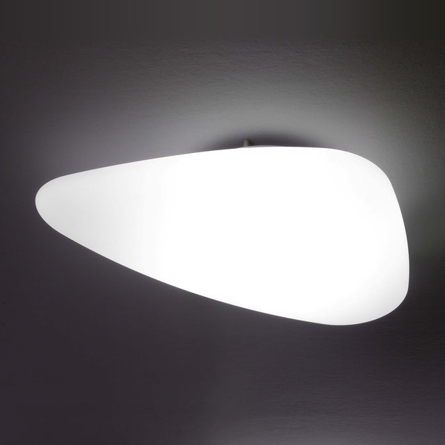 Stone LED Flush Ceiling Light in white, pebble-shaped diffuser glowing softly, mounted flush against a dark background.