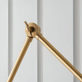 Close-up of the Caldhurst Wall Light's adjustable brass arm joint with knurled wing screw, shown against a light grey background.