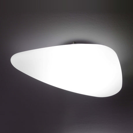 Stone LED Outdoor Flush Ceiling Light in white, a smooth pebble-shaped diffuser with rounded triangular form, mounted flush with no visible frame, glowing evenly against a dark background.