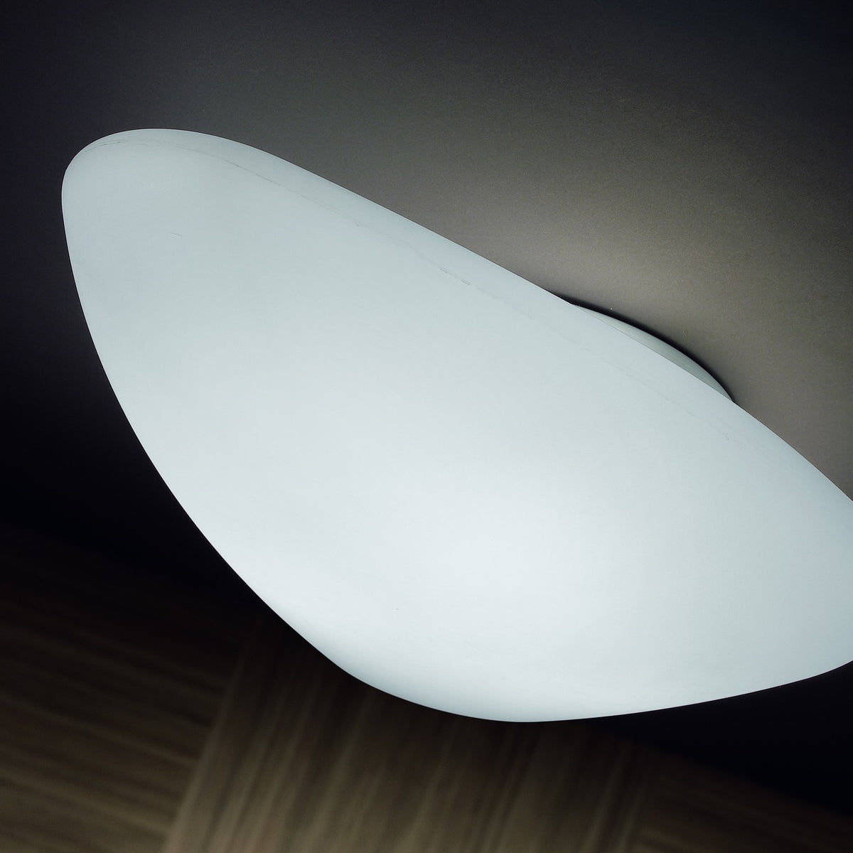 Stone LED Outdoor Flush Ceiling Light in white, pebble-shaped diffuser mounted flush to the ceiling, glowing evenly with no visible frame.