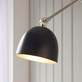 Endon Caldhurst wall light with polished nickel adjustable arm and matt black domed shade with painted inner, mounted against pale grey panelling.