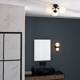 Endon Marden semi-flush ceiling light with three opal glass globes on matt black arms, installed in a modern bathroom with matching wall light and mirror.