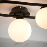 Close-up of Endon Marden semi-flush bathroom ceiling light with two visible opal glass globes on a matt black steel oval frame.