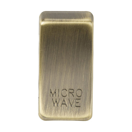 The Switch Cover "Marked MICROWAVE" - Antique Brass is a rectangular, metallic button with an antique brass finish that showcases visible brush strokes, giving it a classic rocker cover appearance. Made from durable ABS construction, its rounded edges contribute to both a sleek and vintage aesthetic.