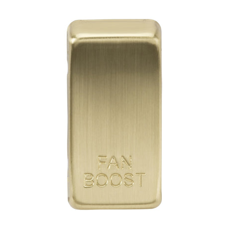 A brushed brass rectangular metal bar labeled as the "Switch Cover 'Marked FAN BOOST'" features the sleek engraving of the words FAN BOOST, offering a polished and refined appearance.