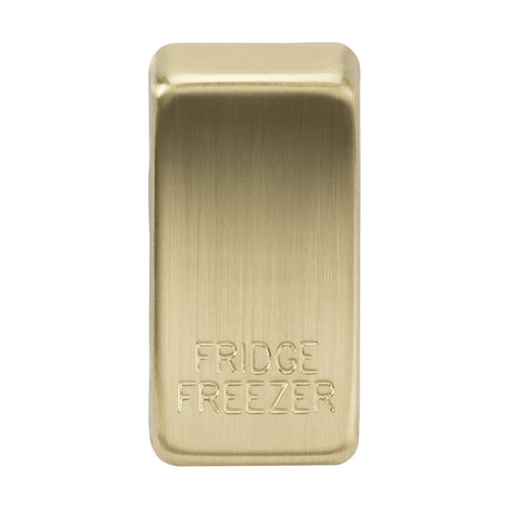 The Switch Cover "Marked FRIDGE FREEZER" in brushed brass is a rectangular switch with a smooth texture, making appliance control effortless and stylish with its rocker covers. It is clearly labeled with "FRIDGE" at the top and "FREEZER" at the bottom, featuring AB construction.