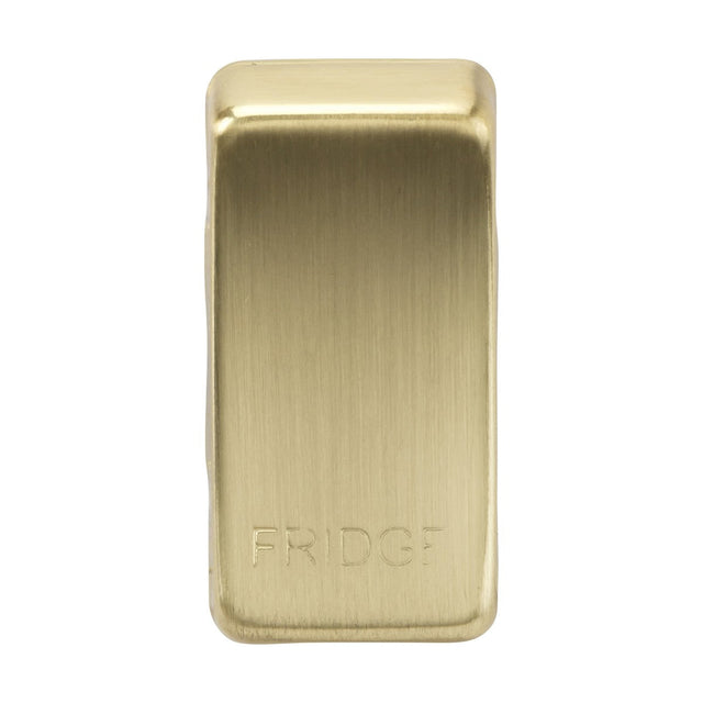 A rectangular fridge door handle, known as the "Switch Cover 'Marked FRIDGE'," is crafted in brushed brass with a metallic gold finish. The word FRIDGE is engraved near the bottom, and it features a minimalist and modern design made from ABS construction.