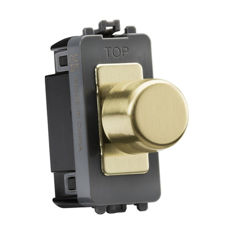 A 6A 1 Gang 2-Way Dummy Dimmer Module in brushed brass, featuring a round knob and mounted on a black rectangular base. The base includes TOP and MADE IN CHINA markings, along with electrical specifications on the side.