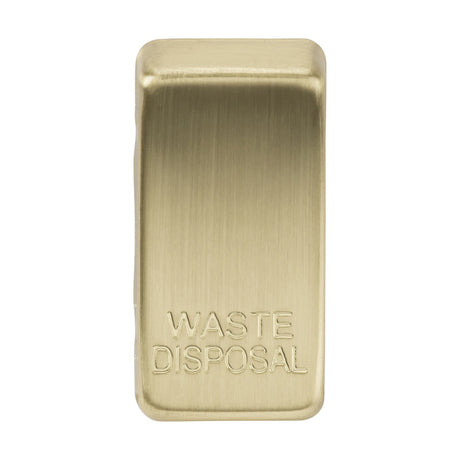 Introducing the Switch Cover "Marked WASTE DISPOSAL" in Brushed Brass, showcasing a brushed metallic finish and a sleek rectangular design with smooth, rounded edges, embodying impeccable craftsmanship that rivals high-quality ABS construction.