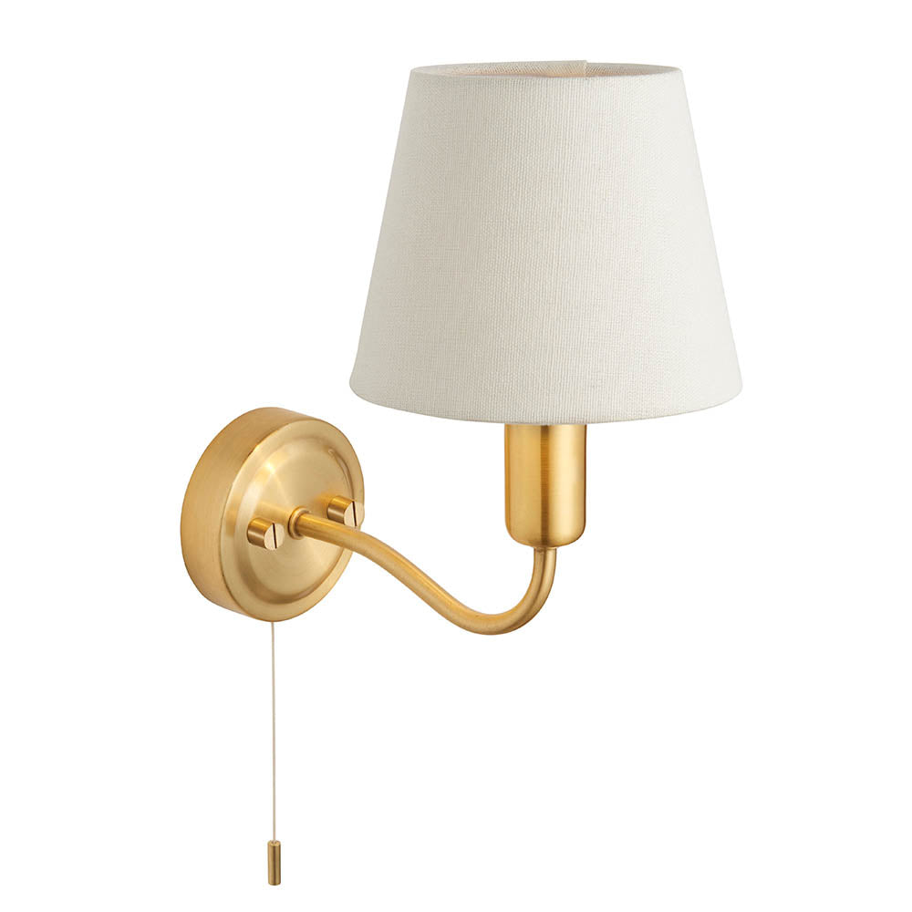 Endon Bevton IP44 bathroom wall light with curved satin brass arm, single G9 lamp, ivory fabric shade and pull cord, on a plain white background.