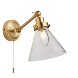 Endon Brackwood bathroom wall light in brass with adjustable arm, clear glass cone shade, G9 bulb and pull cord switch, on a white background.