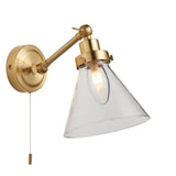 Endon Brackwood bathroom wall light in brass with a single adjustable arm, clear glass conical shade, G9 bulb and pull cord switch on a white background.