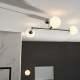 Kelham 3-light semi-flush bathroom ceiling light in chrome with angular arms and round white glass globe shades, fitted to a white ceiling.