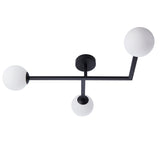 Endon Kelham 3 light semi-flush bathroom ceiling light in black with three white glass globe shades on angled arms, shown on a white background.