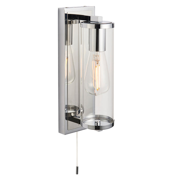 Endon Cranfield bathroom wall light in chrome with a clear glass tubular shade, E27 filament bulb, and pull cord switch on a plain white background.
