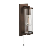 Cranfield Bathroom Wall Light in bronze with rectangular back plate, ribbed clear glass tube shade, visible bulb, and pull cord switch.
