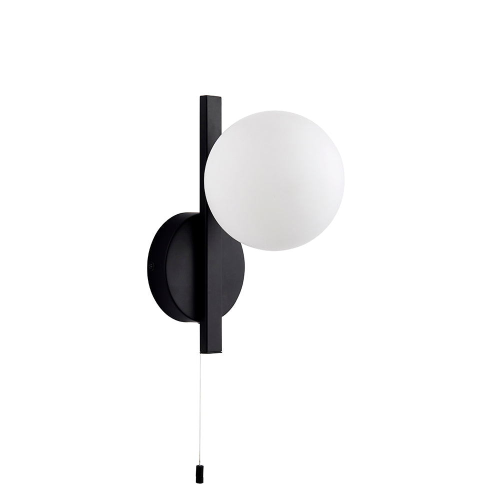 Kelham Bathroom Wall Light in black with a round opal glass globe on a rectangular backplate and pull-cord switch, shown on a plain white background.