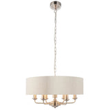 Brenley 6-light pendant with beige fabric drum shade, six chrome candle arms and E14 bulb holders, hung on a nickel chain against a plain white background.