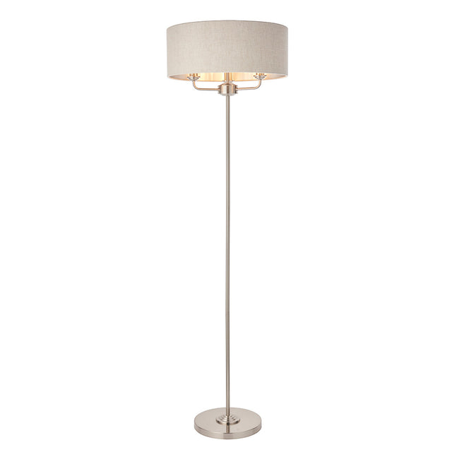 Brenley 3 Light Floor Lamp in brushed chrome with a wide linen drum shade and slim stem base, shown on a plain white background.