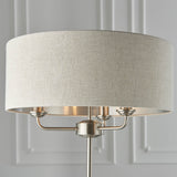 Close-up of the Brenley 3 Light Floor Lamp in brushed chrome, showing three E14 fittings beneath a natural linen drum shade with reflective inner lining.
