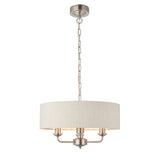 Brenley 3 Light Pendant in white and chrome with a round linen drum shade, three candle-style arms, chain-hung from a chrome ceiling mount.