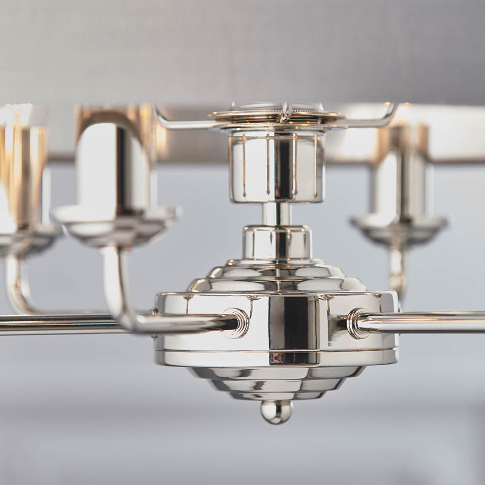 Close-up of the Endon Brenley V2 6 Light Pendant showing the polished nickel hub, tiered finial, and arms with candle-style holders beneath a grey shade.
