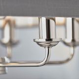 Close-up of Endon Brenley V2 6 Light Pendant showing polished nickel arm, cup fitting and chrome lamp holder beneath a charcoal linen shade.
