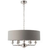 Endon Brenley V2 6-light pendant with a large grey linen drum shade and nickel and chrome arms on a chain suspension, shown on a white background.