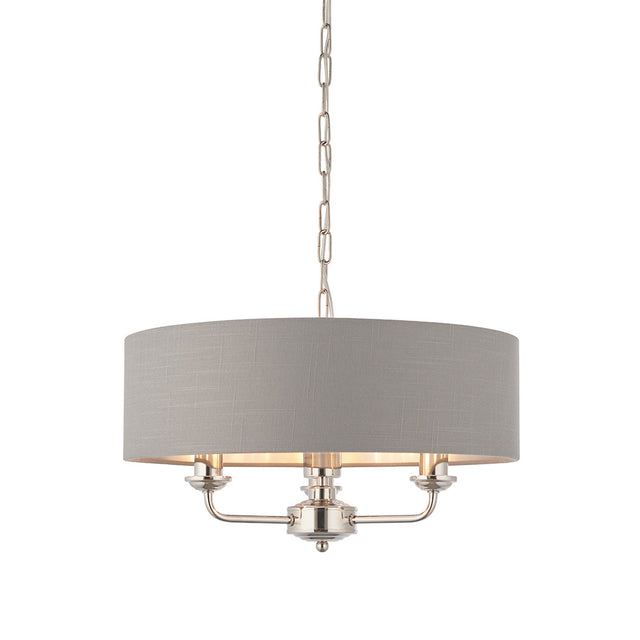 Endon Brenley V1 3-light pendant with a grey linen drum shade, nickel three-arm fitting and suspension chain, shown on a plain white background.