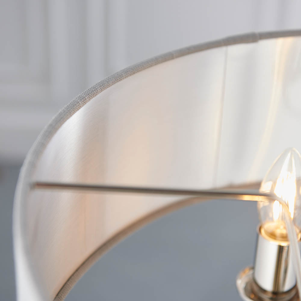 Close-up of Endon Brenley V1 3 Light Pendant showing the linen shade's brushed metallic inner lining, nickel frame arms, and a lit clear E14 candle bulb.