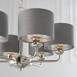 Close-up of the Endon Brenley six-light pendant showing polished nickel arms and charcoal grey linen shades with brushed metallic inner linings.
