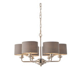 Endon Brenley V3 six-light pendant in nickel and chrome with grey linen drum shades on a chain suspension, shown on a plain white background.