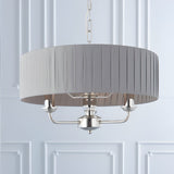 Brenley V2 3-light pendant in nickel with a grey pleated fabric drum shade, three candle-style arms, and chain suspension.