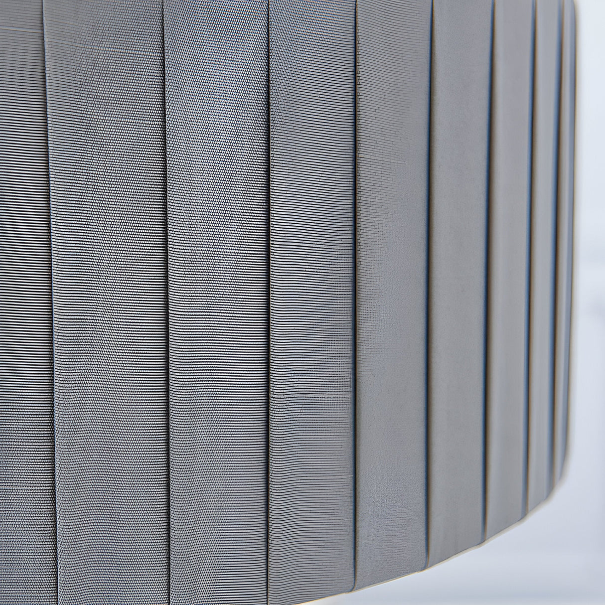 Close-up of the Brenley V2 3 Light Pendant's pleated grey linen fabric shade with nickel-toned trim, showing textured vertical fabric folds.